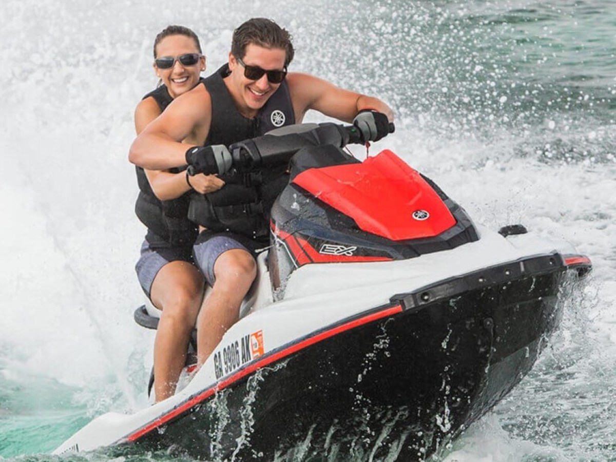 a person riding on the back of a boat in the water